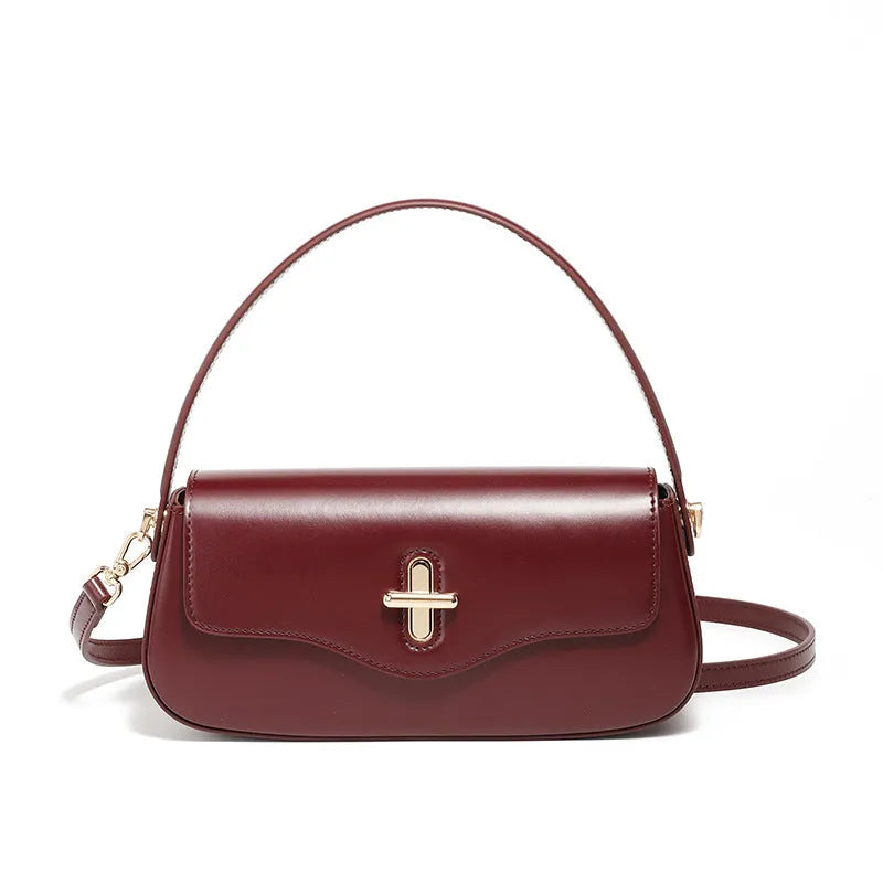 Genuine leather baguette handbag in caramel colour with clamshell design and shoulder straps