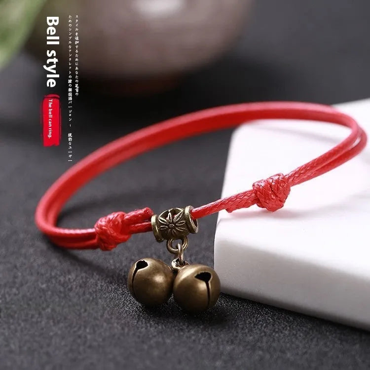 Adjustable nylon dog collar with brass bell and buckle in black, red, or coffee rope.