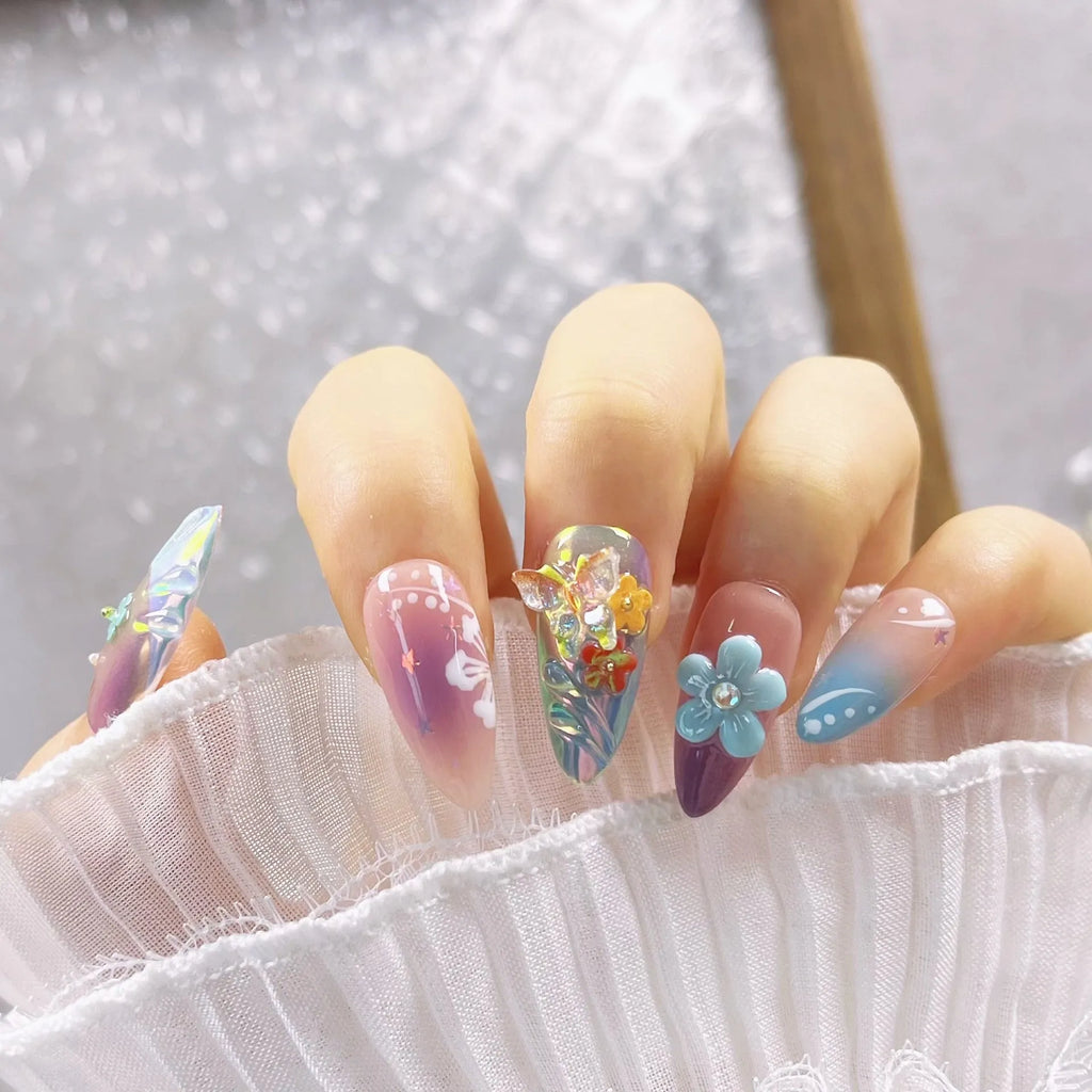Handmade colourful nail art set with embossed small flower and butterfly sculptures for almond-shaped manicures.