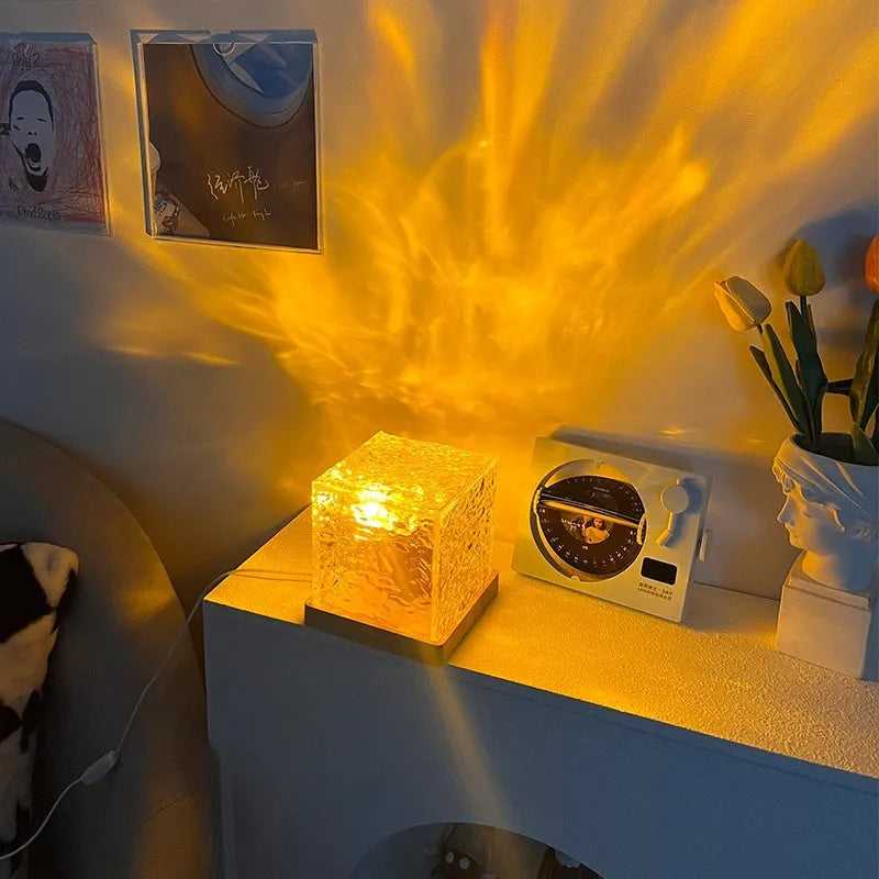 LED water ripple night light with rotating crystal projection and remote control on wooden surface