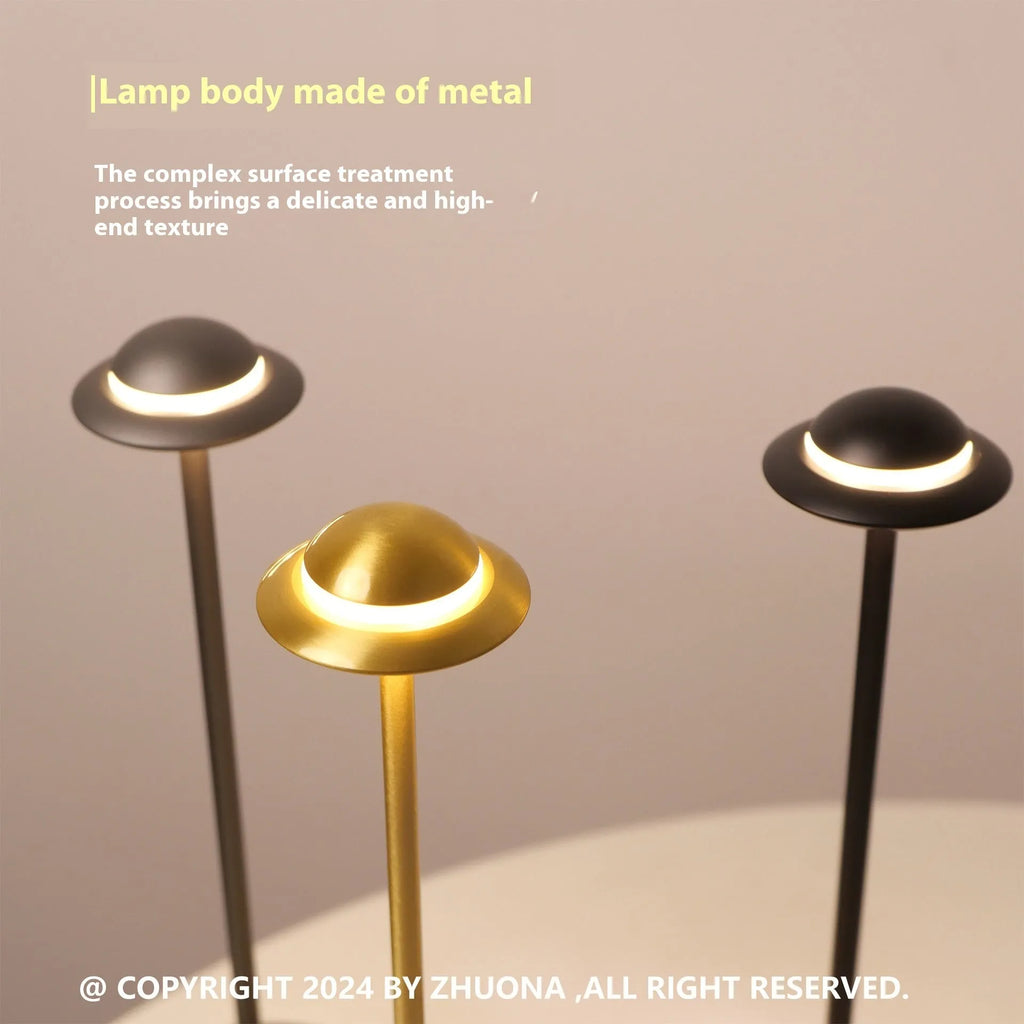 Modern metallic UFO-shaped rechargeable table lamp with touch dimming in black finish.