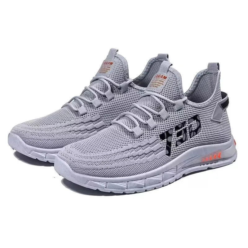 Low-top casual sneakers with mesh upper in colours black, grey, and beige on a flat plastic sole