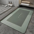 A rectangular blue blended floor mat on a wooden bathroom floor.