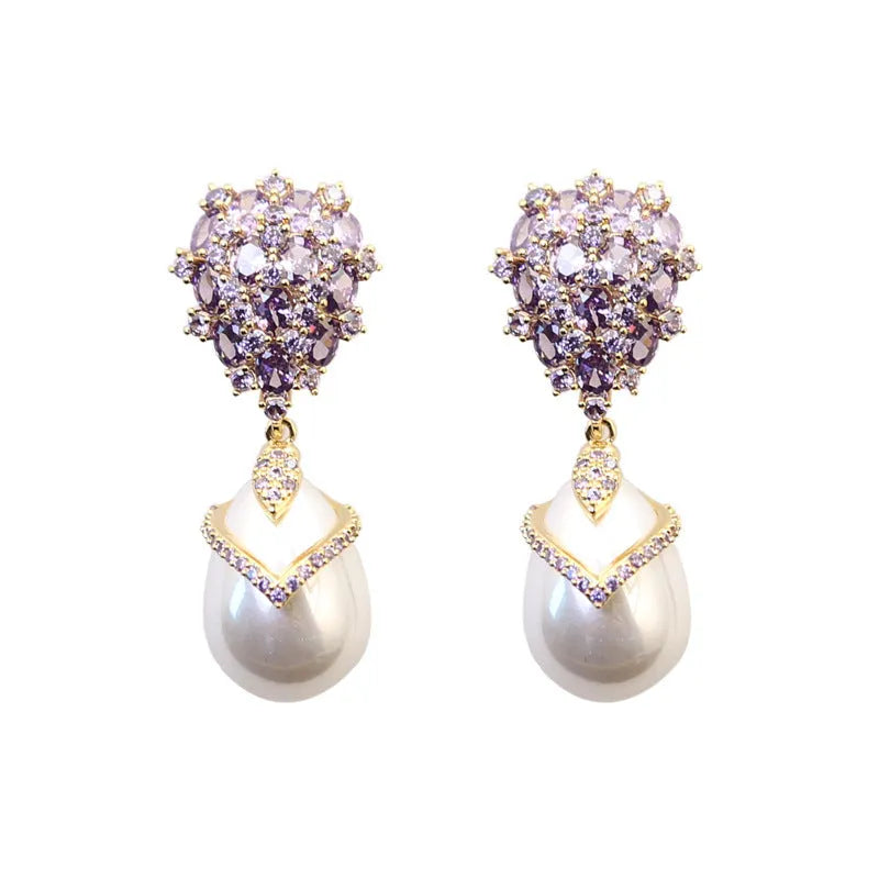 Women's drop-shaped pearl earrings with zircon stone accents and 18K gold plating.