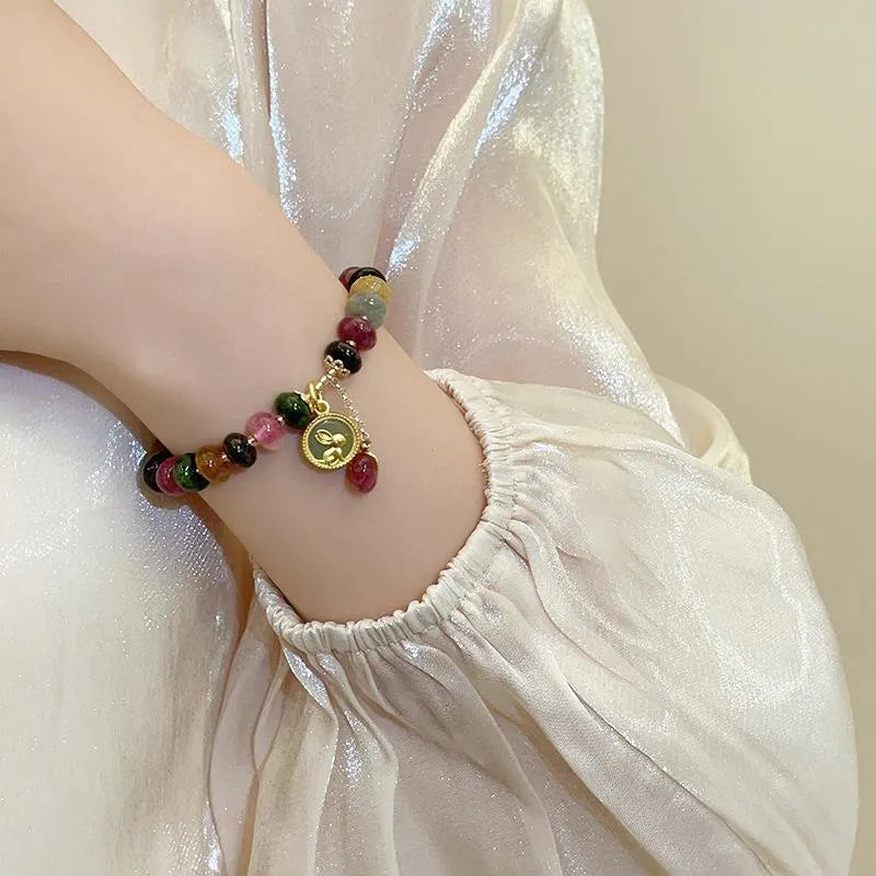 Colourful tourmaline abacus bead bracelet with rabbit pendant charm on wrist