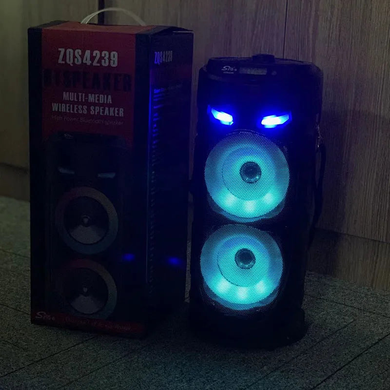 Black portable Bluetooth speaker with dual horn design and wheat detailing, showing USB port and card slot