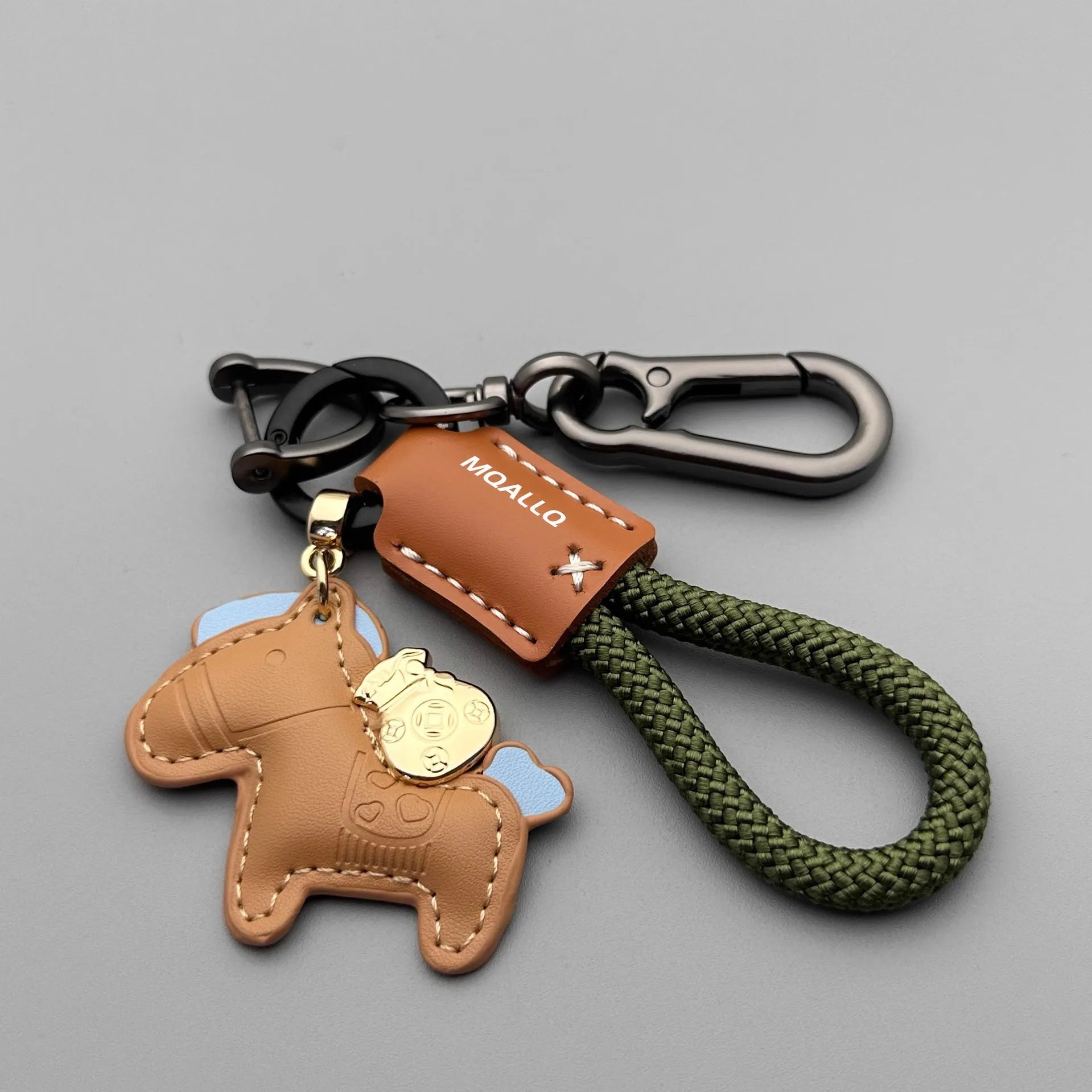 Handmade brown cowhide leather keychain with a silver pony belt buckle charm and green velvet rope.