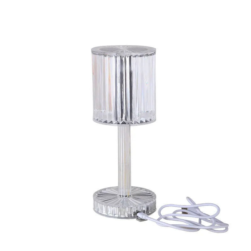 Modern crystal table lamp with a diamond-faceted shade on a metal stand, showing amber colour option.