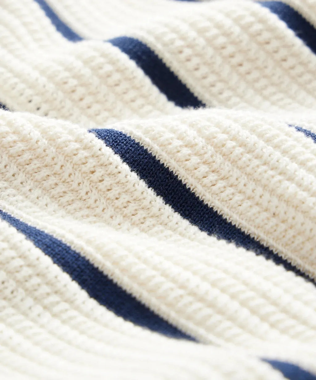 White men's knitted shirt with asymmetric stripes and a V-neck lapel, short sleeves, British style leisure wear.