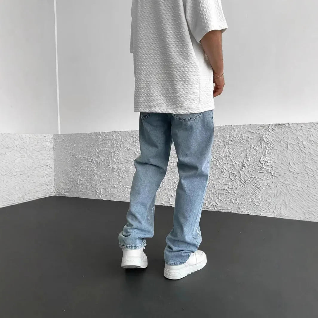 Men's blue straight-leg denim jeans with wide-leg fit and medium elasticity