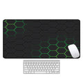 Large desk pad with printed pattern on a wooden desk, showing non-slip rubber base.