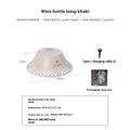 Beige rechargeable camping lantern with a wine bottle-shaped shade showing its USB-C port and gear switch.