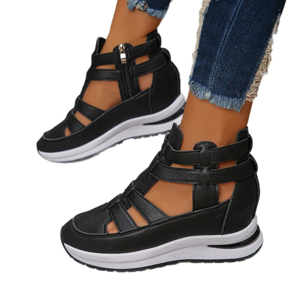 Black women's close-toed hollow-out platform sandals with Velcro strap on a white background