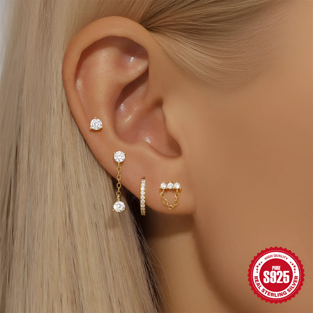 Close-up of geometric S925 sterling silver earrings with a gold electroplated clover petal design.