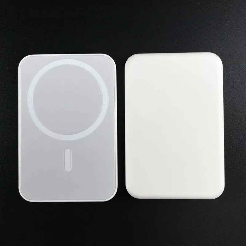 White foot-shaped portable power bank with magnetic wireless charger on a table.