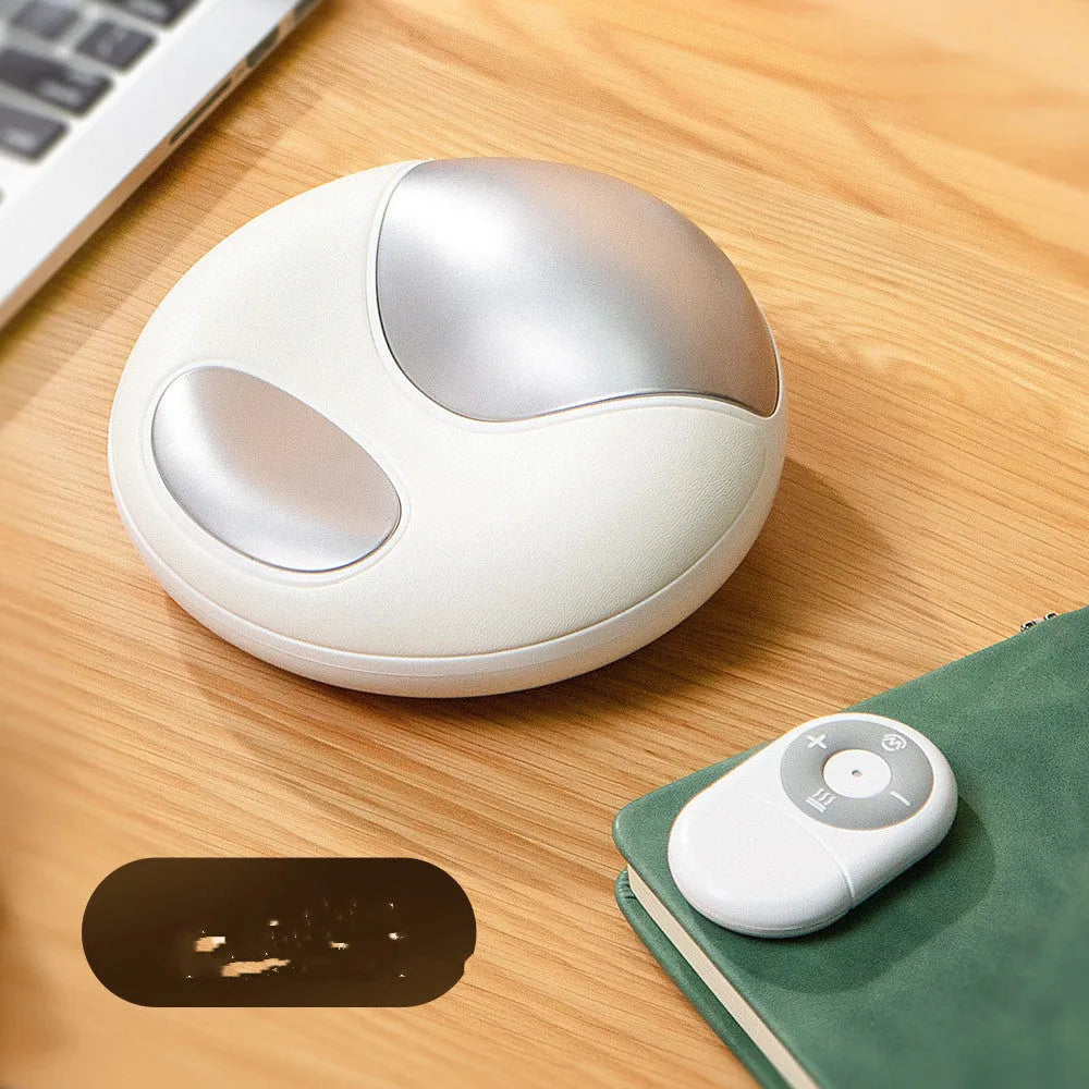 Smart electric hand massager with heat compress in pink and white on desk
