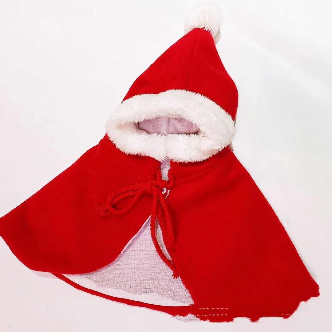 Red cloth shawl cloak clothing on a small dog with Christmas pattern background