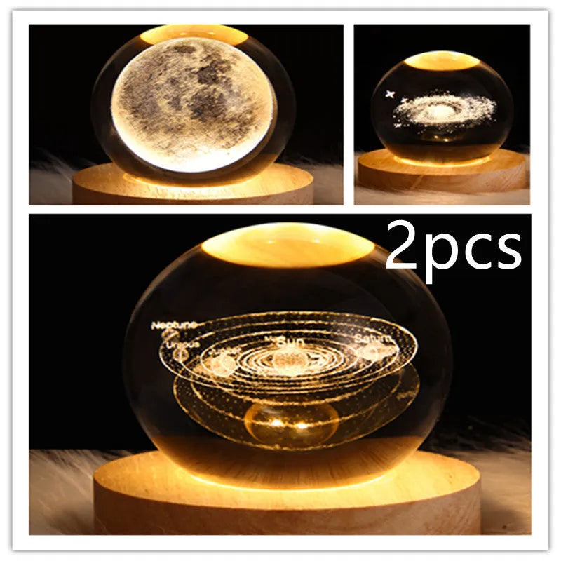 LED galaxy crystal ball night light with 3D planet designs on a table