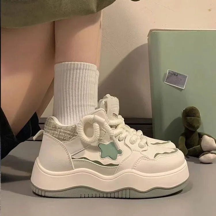 Women's green patent leather platform sneakers with front lace-up closure and rubber sole