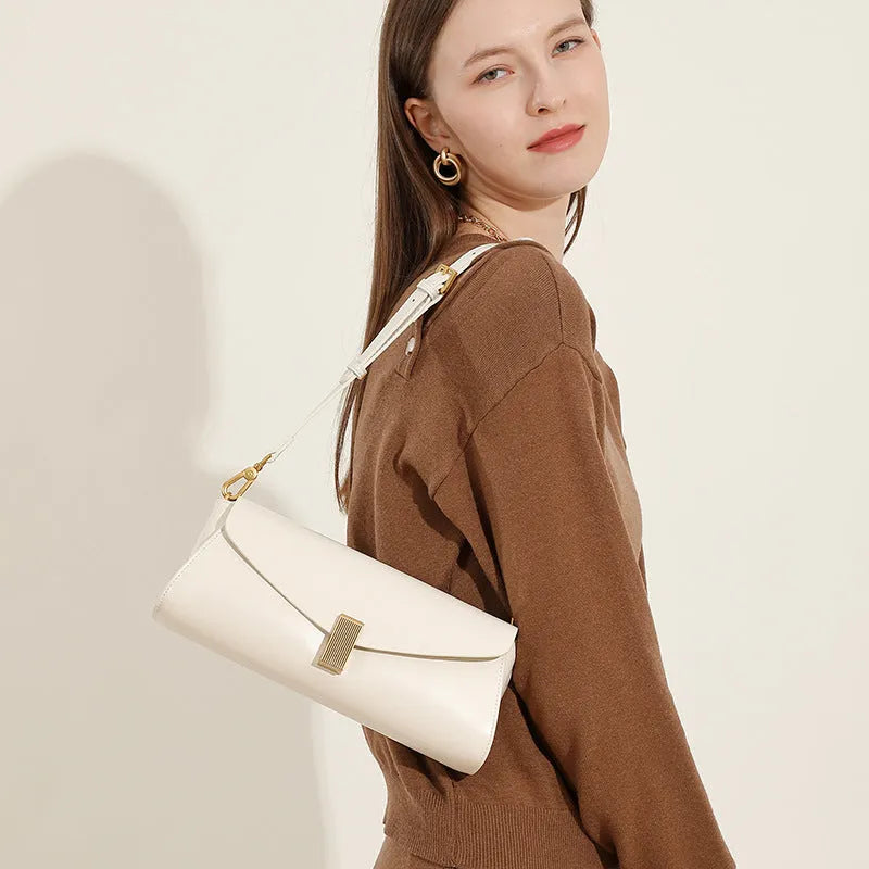 Cowhide leather women's cross-body bag in a clamshell, pillow-shaped design.