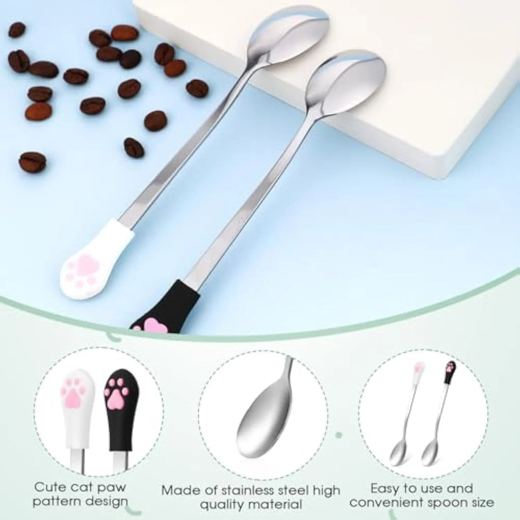 Two pet food spoons with cat paw designs in white and black colours