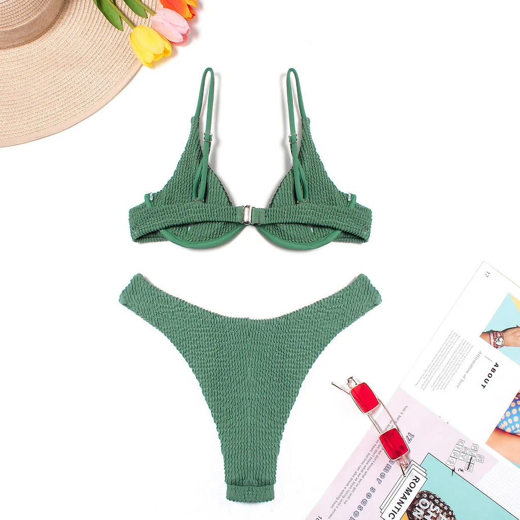 Green women's bikini set with ruffle trim, showing top and split briefs made from quick-dry polyester fabric.