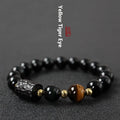 Obsidian bracelet with yellow tiger eye beads showing retro circular design