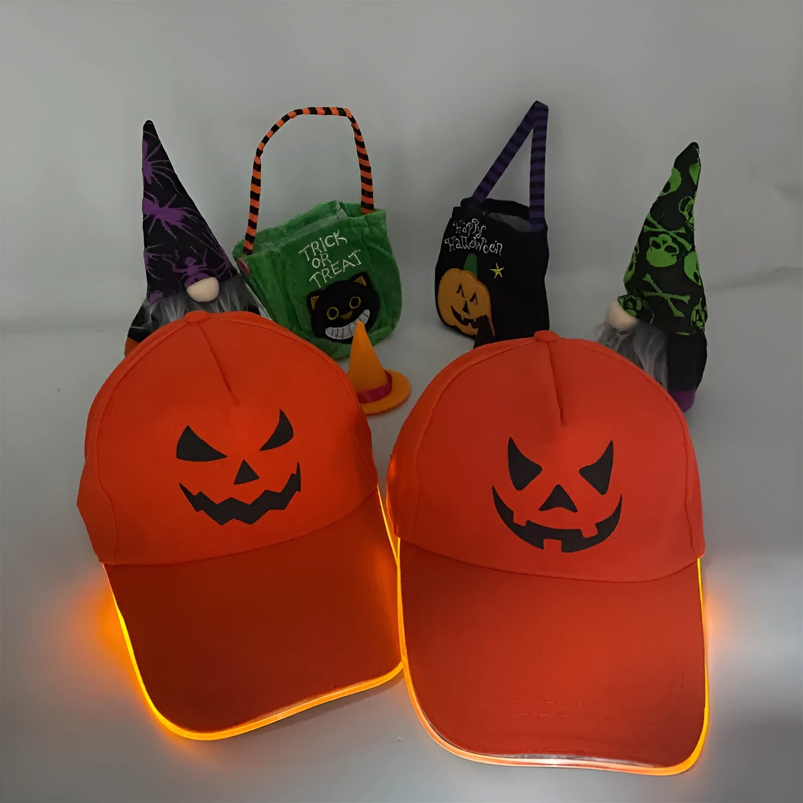Black Halloween baseball cap with LED pumpkin smile face and yellow lights illuminated.