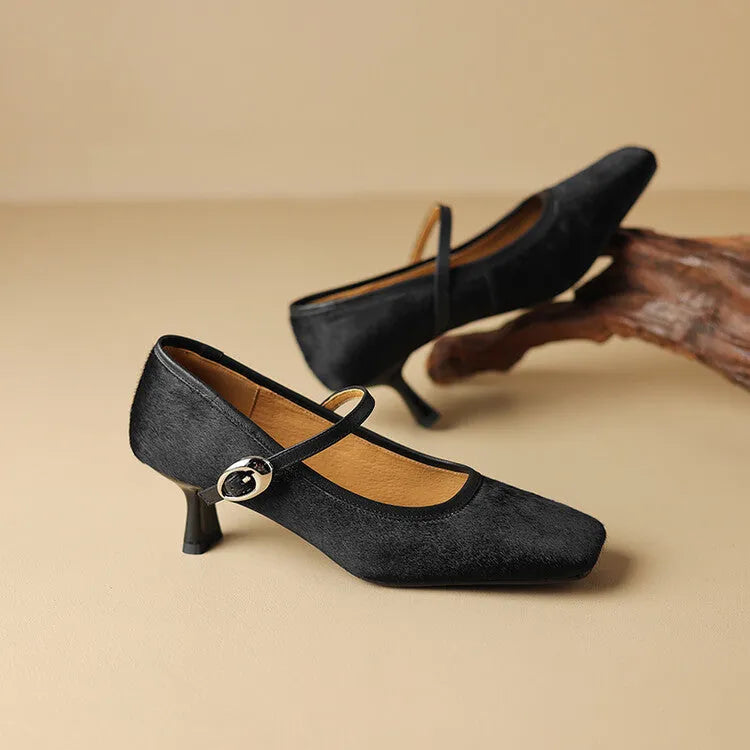 Women's black square toe stiletto heel ankle-strap shoes with horse hair upper on a model.