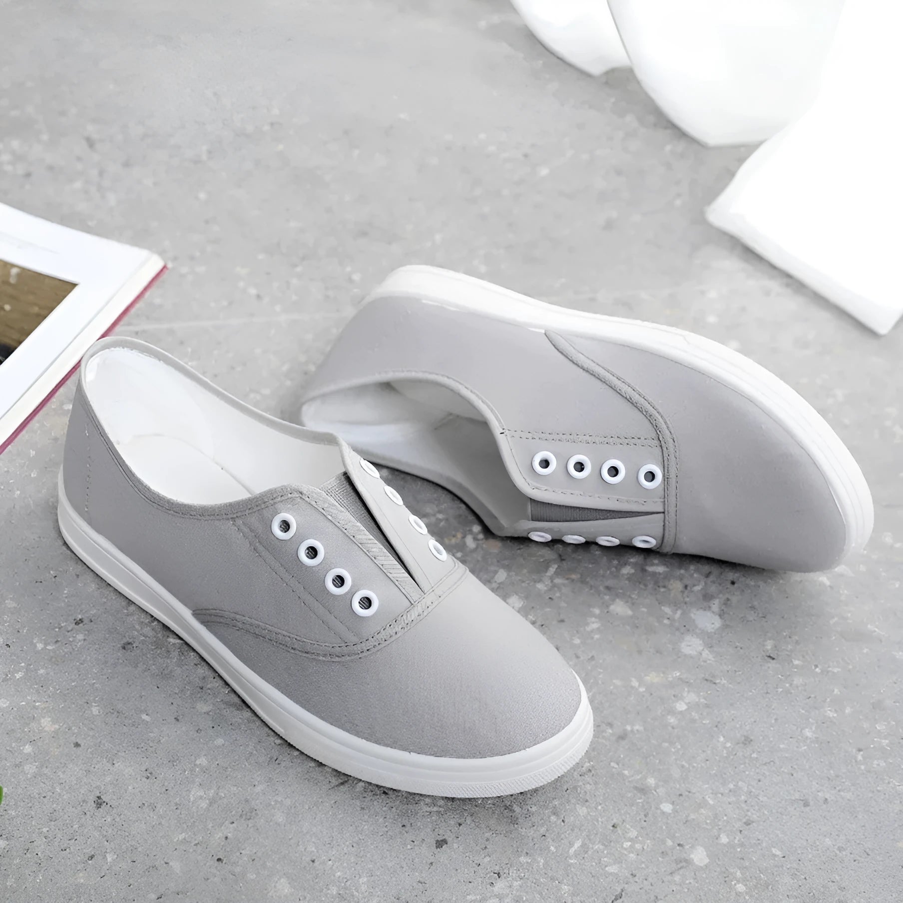 A pair of low-top canvas casual shoes in a choice of colours, featuring a flat heel and cloth lining.