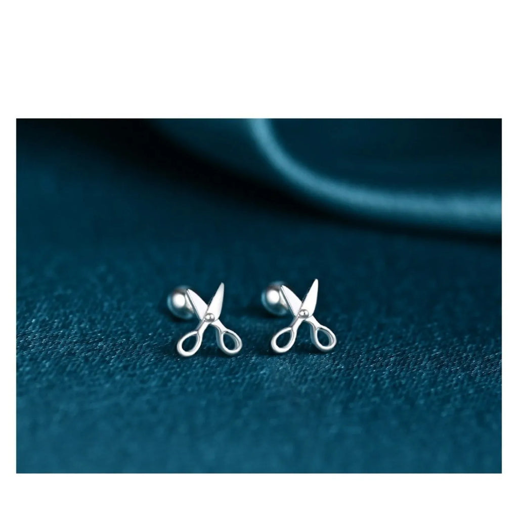 Pure silver ear nails with screw fitting showing miniature scissors and screw decorative designs