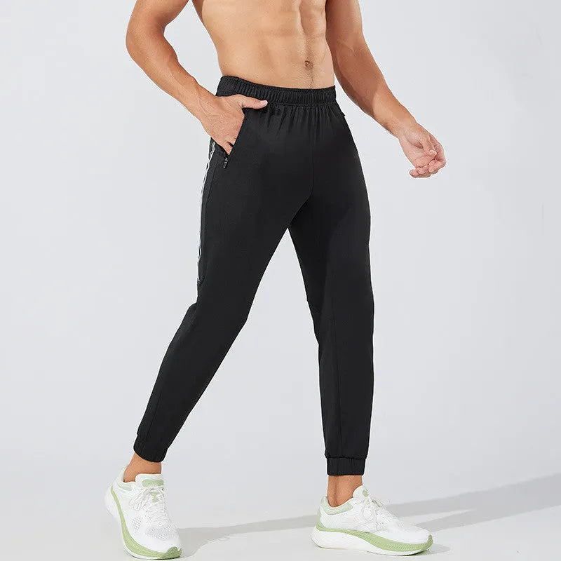 Black and navy blue men's polyester running trousers with mid-waist and long leg