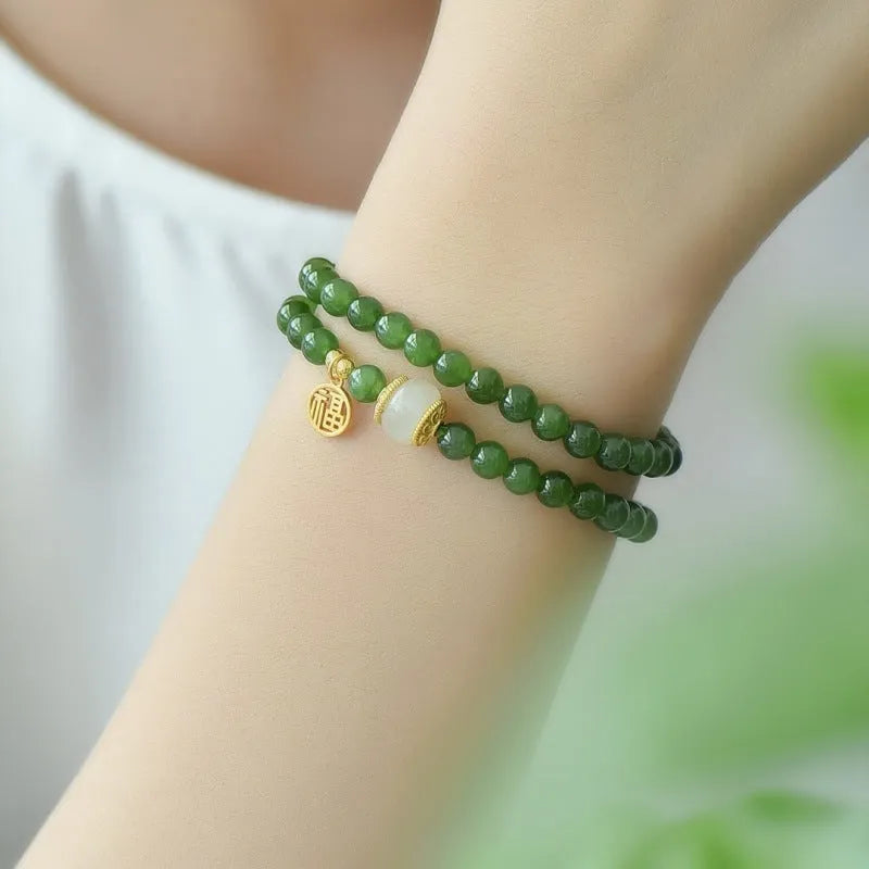 Women's double circle bracelet made from natural Hetian jade with 6mm geometric beads and a fu charm.