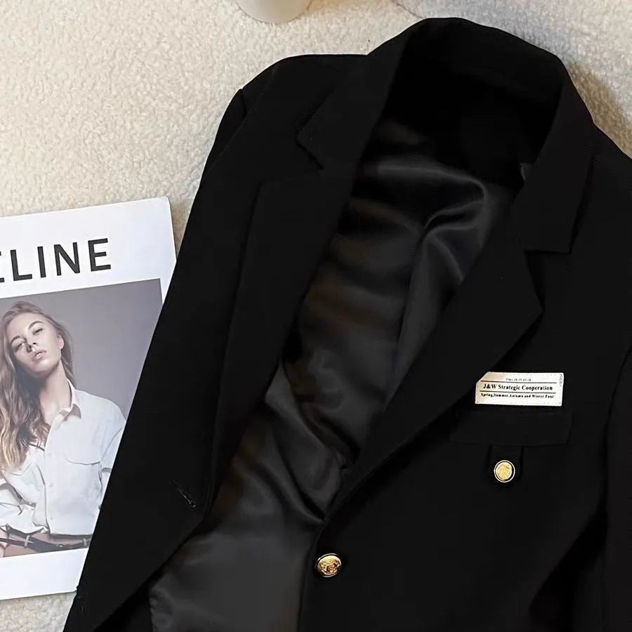 Women's black loose fit polyester short suit coat with long sleeves and pocket detailing