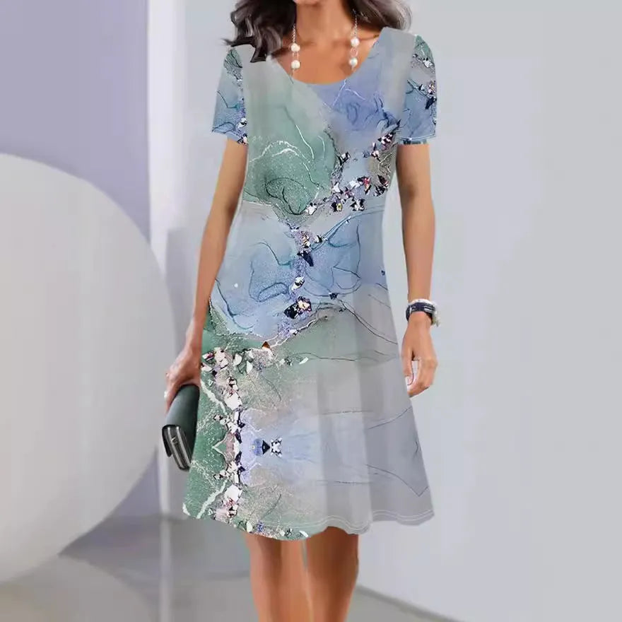 Women's mid-length summer dress with a floral print on light fabric, showing short sleeves and an A-line skirt.
