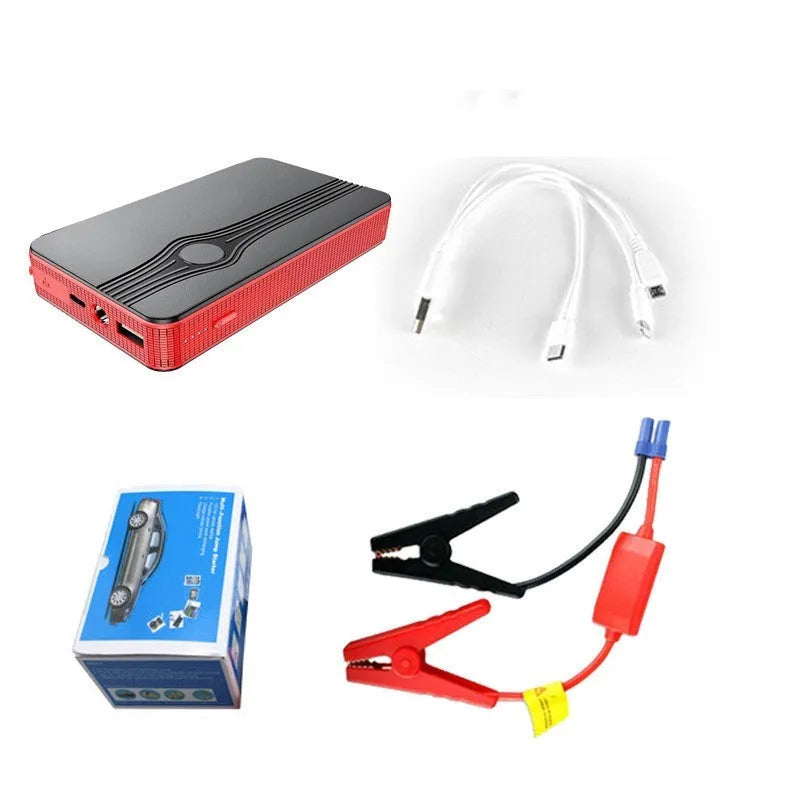 Red K4-E automobile emergency jump starter power supply unit with a USB cable on a table.