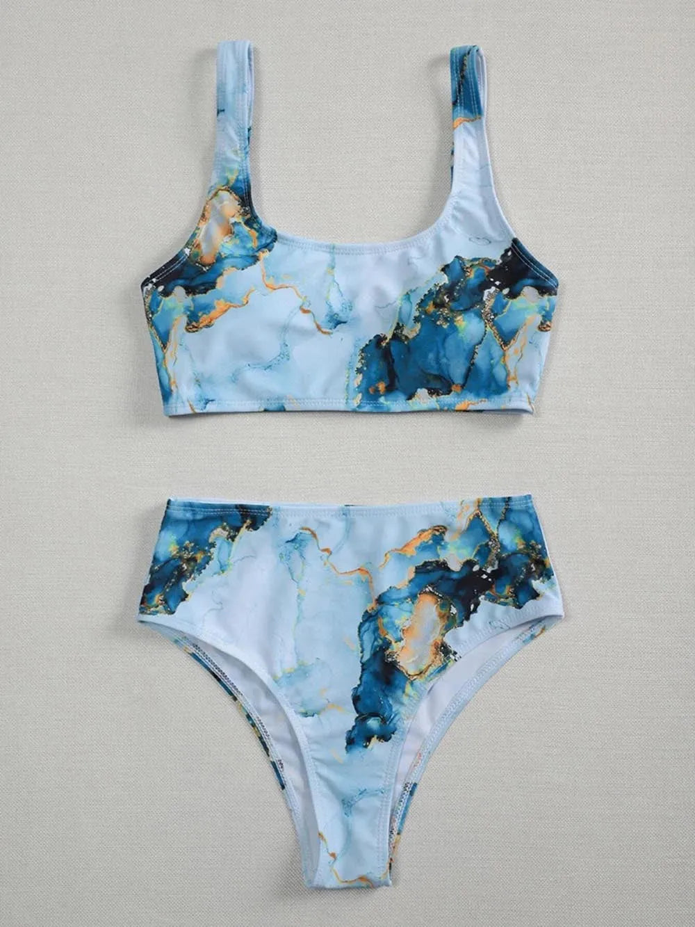 Women's high waist bikini set in a marble tie-dye print, showing U-neck top and briefs.