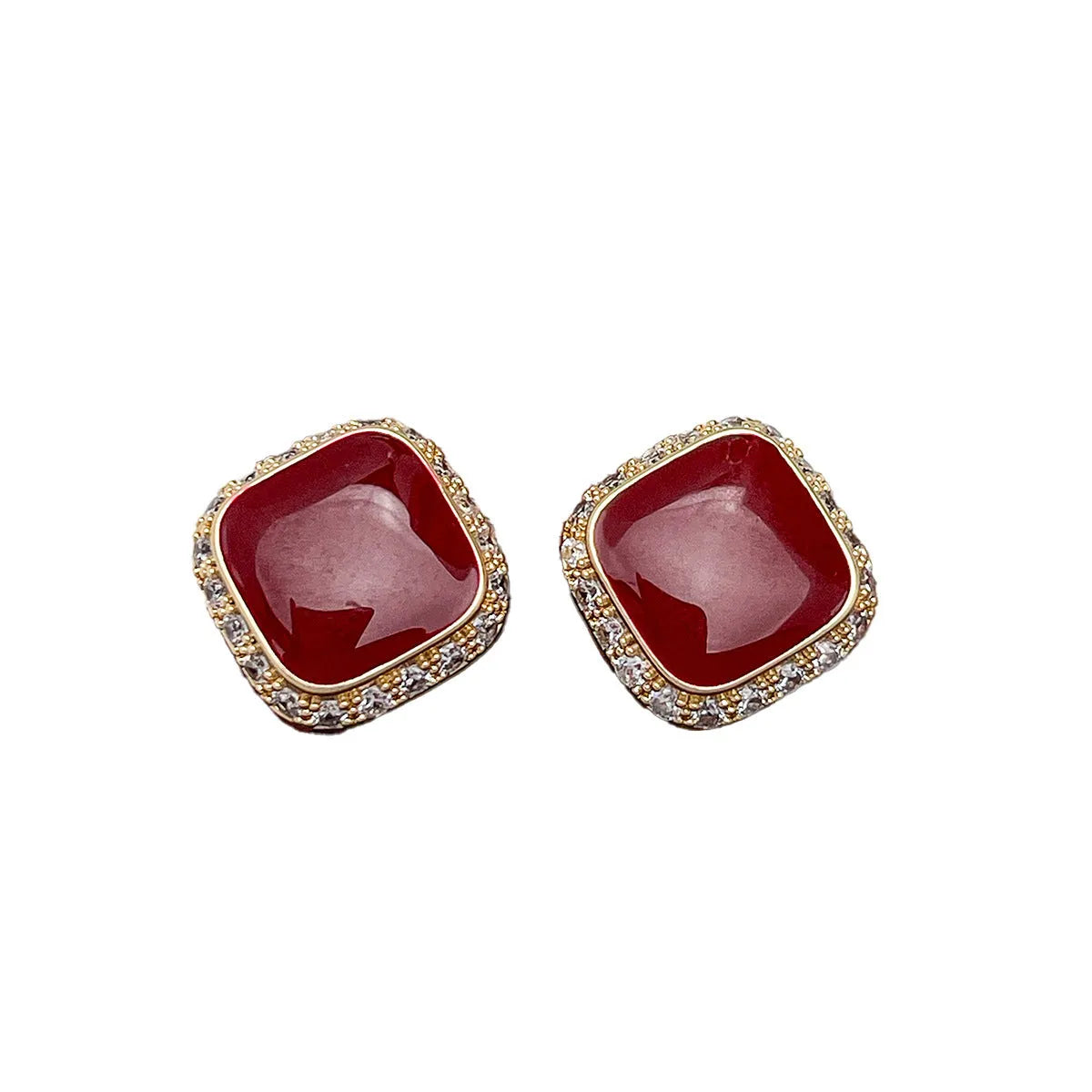 A pair of red geometric square alloy earrings with an inlaid plate design, showing front view.