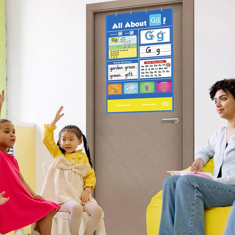 Large fabric alphabet learning chart with sets of educational word cards, letter cards, and picture cards arranged around it.