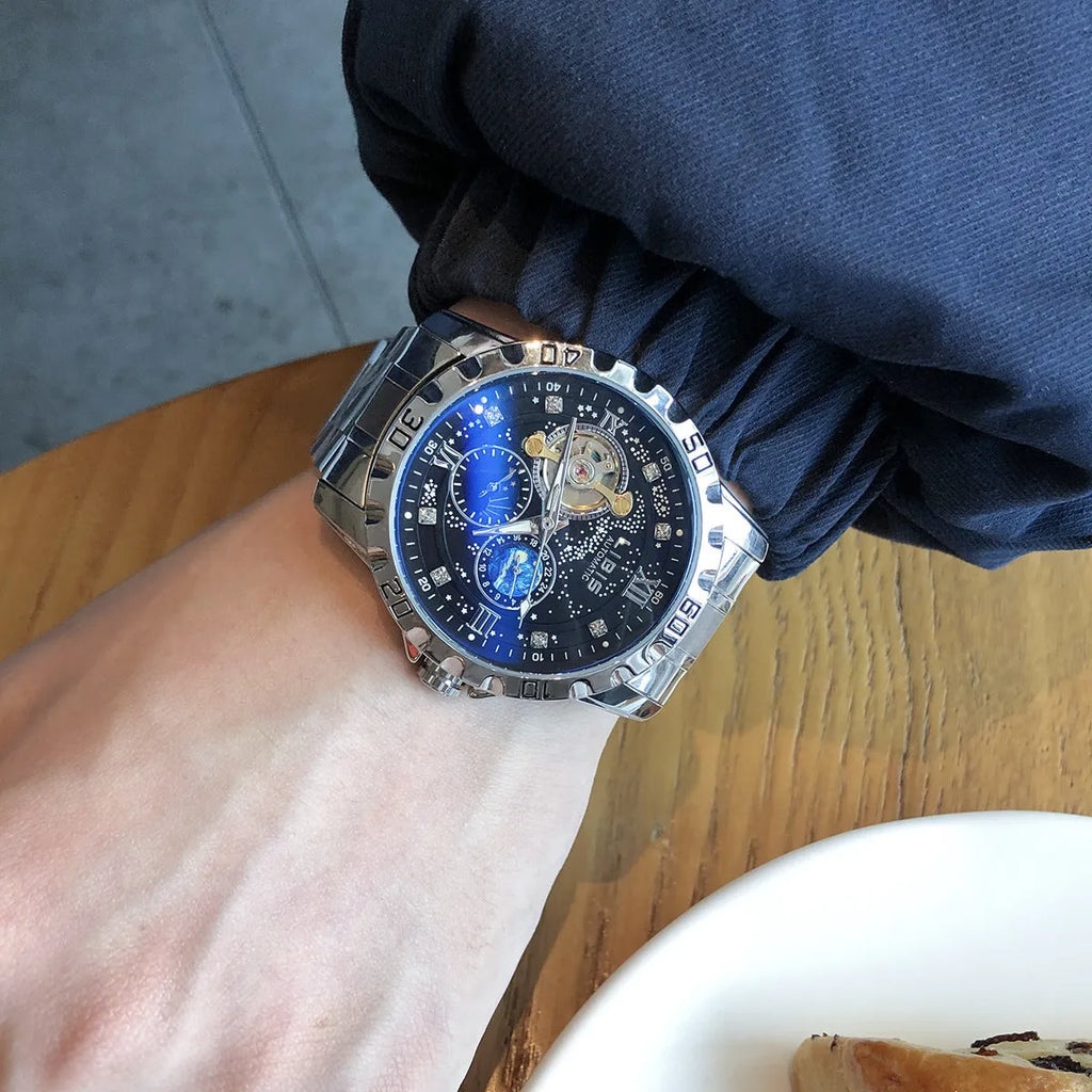 Men's silver case black dial automatic watch with luminous hands on a leather strap