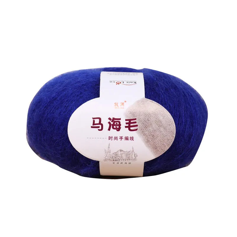 A ball of mohair yarn in a selected colour next to a hand-woven scarf example, showcasing the DIY kit.