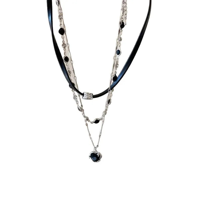 Close-up of a women's multi-layer heart necklace with a leather pendant on an adjustable alloy chain.