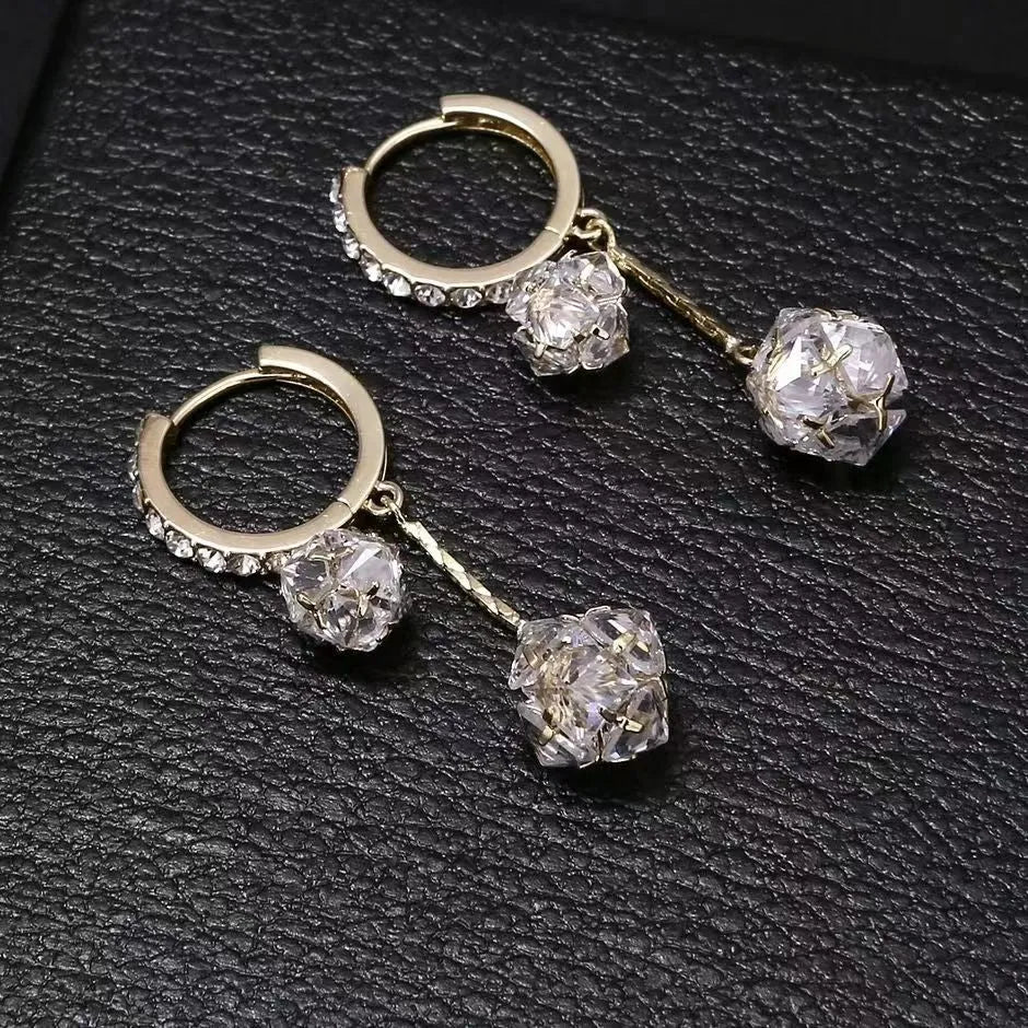 Silver drop earrings for women with a tassel ball and rhinestone ball pendant design.