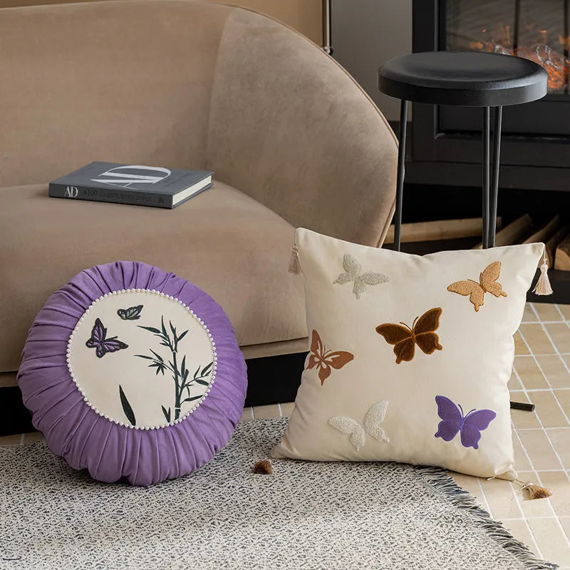 Square beige cushion with detailed Chinese butterfly embroidery design.