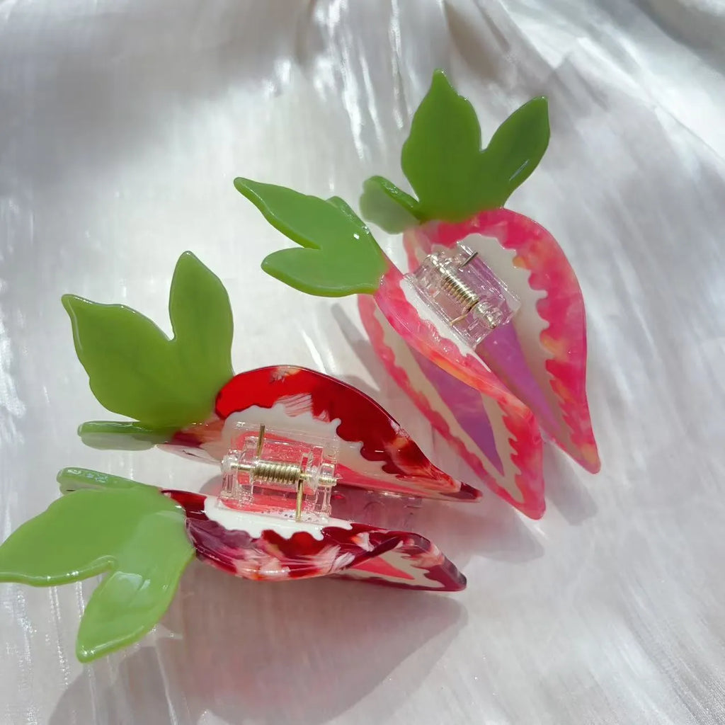 A red or pink hairpin featuring a sweet strawberry fruit design in a pastoral style.