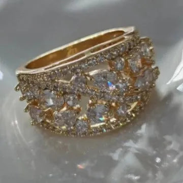 Women's hollow round copper fashion ring with gemstone, shown in gold and platinum colour options.