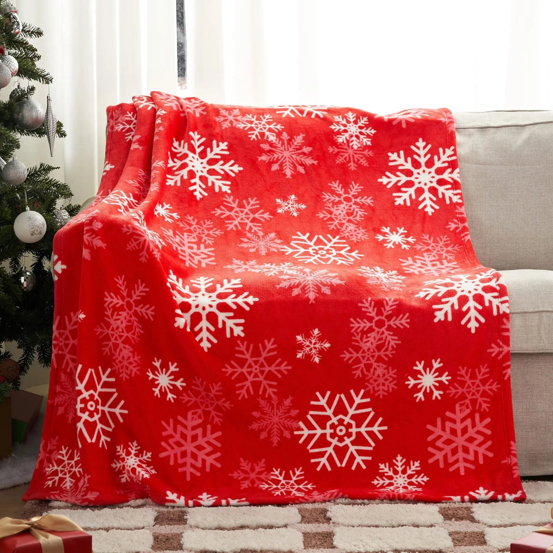 Soft red plush Christmas blanket draped over a sofa corner.