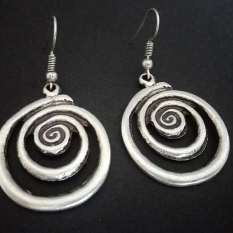 Silver geometric spiral earrings with distressed finish showing 2.6cm width and 5cm length
