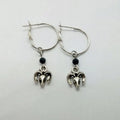 A pair of silver-coloured alloy round ring earrings featuring a Tibetan antelope design.