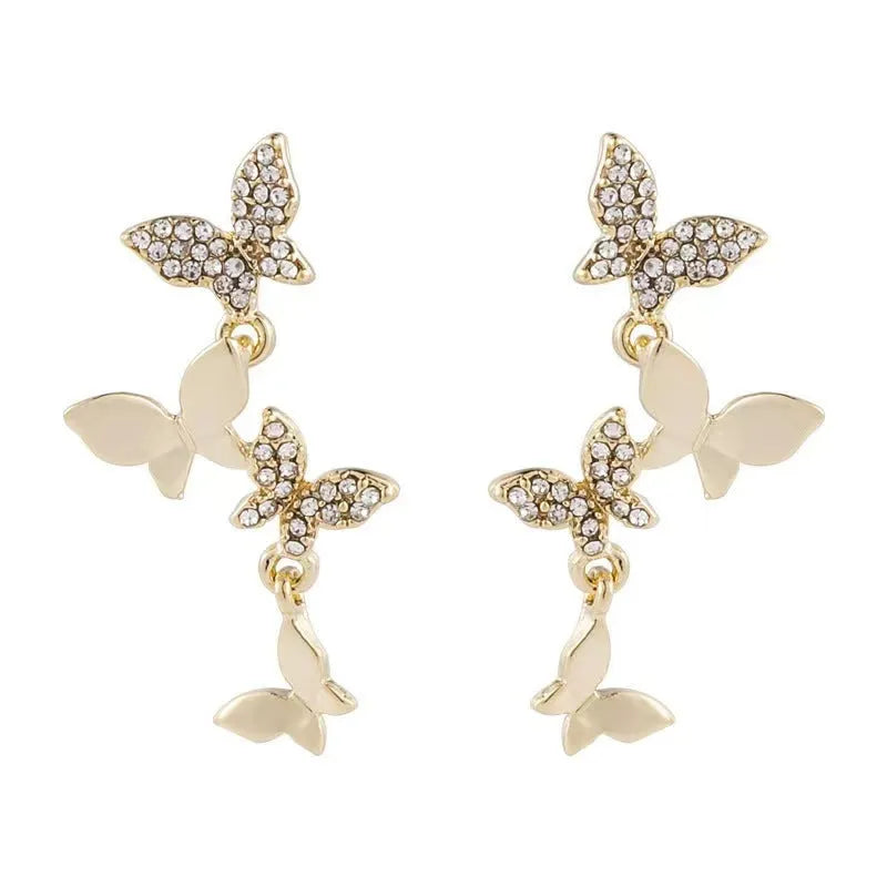 Gold-coloured copper butterfly drop earrings showing four butterfly designs